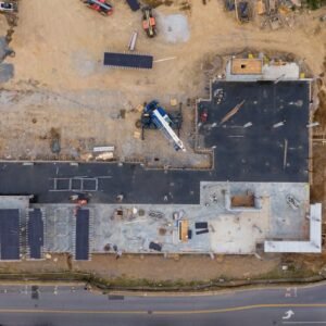 Aerial view of an active construction site with machinery and vehicles.
